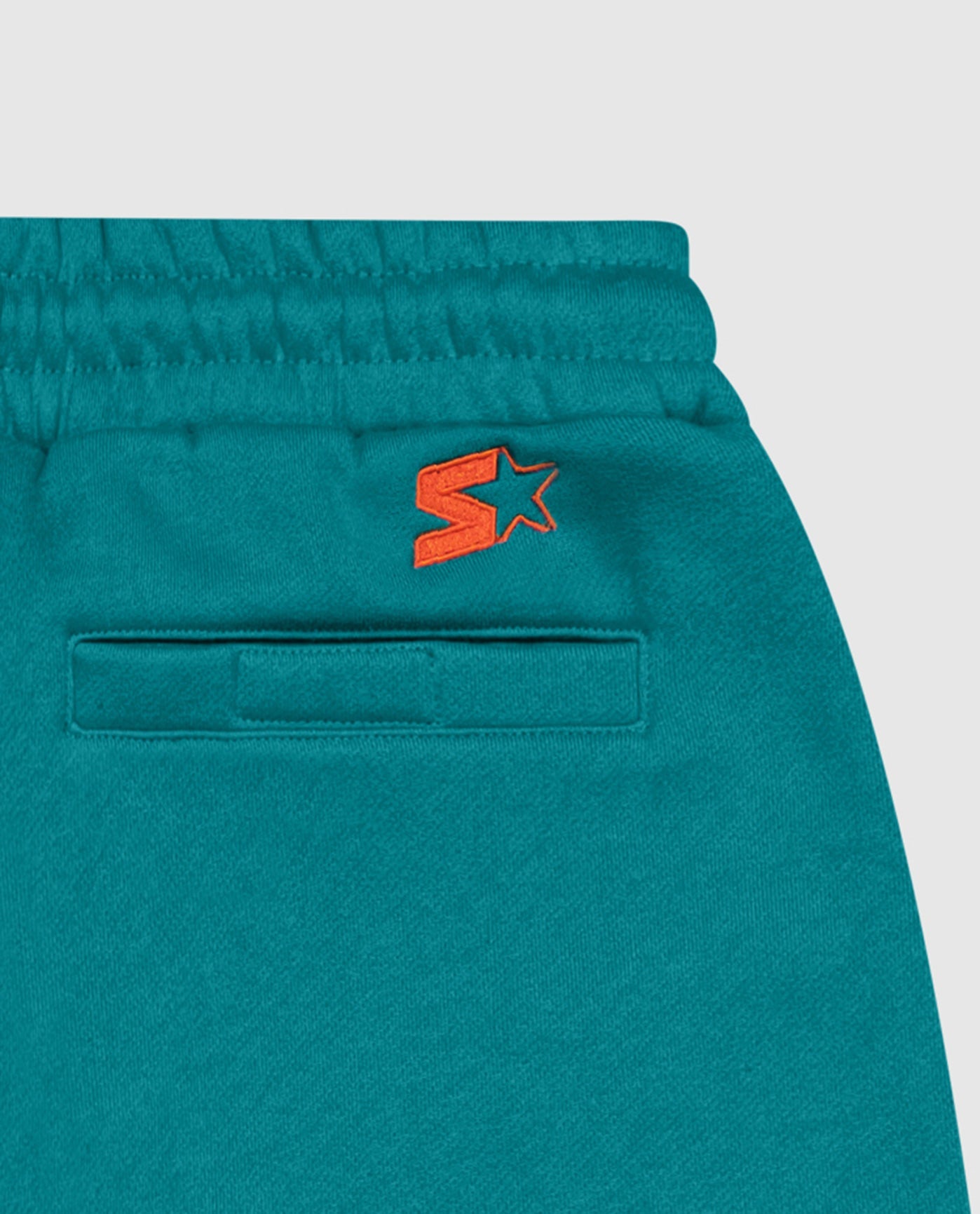 Starter logo below the right waist back graphic | Dolphins Aqua